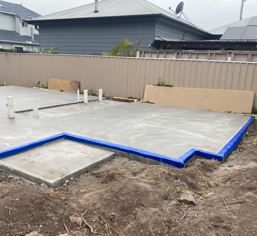 A freshly poured slab with a termite collar around the perimeter